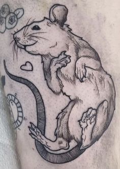 a tattoo with a rat on it's leg