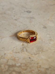 This ring has a dazzling middle stone in a ruby red color on a golden, textured band.  The Green Stone Ring in the video is not included with purchase. Water & sweat-resistant. Every purchase includes a gift box. Thank you for browsing the collection! :) Ruby Red Color, Green Stone Ring, Red Stone Ring, Green Stone Rings, Red Stone, Green Stone, Ruby Red, Stone Ring, Rings Statement