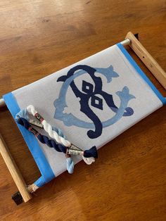 a blue and white rug sitting on top of a wooden floor next to a pair of scissors