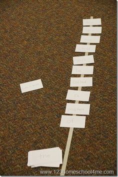 several pieces of paper taped to the floor with words written on them and pinned together