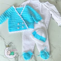 a blue and white knitted baby outfit with matching booties