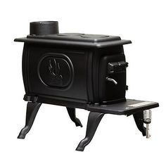 an old fashioned black stove sitting on top of a stand