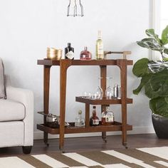 a living room with a couch, coffee table and liquor bottles on the shelf next to it