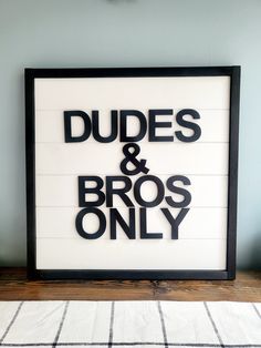 a sign that says dudes and bros only on the side of a wall in a room