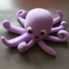 an octopus stuffed animal sitting on top of a table