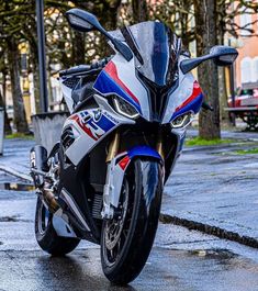 the motorcycle is parked on the wet street