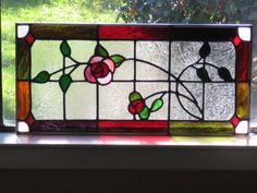 a stained glass window with roses on it