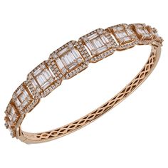 Tinged with moments of retro glamour and drenched with sparkling stones, this stylish Diamond Tapered Bangle Bracelet designed by Spectra Fine Jewelry in 2019 features 345 diamonds—both round brilliant-cut and baguette—weighing approximately 4.20 carats of G-H colors and VS-SI clarity. The 18k rose gold bangle is embellished with delicate filigree and features nine geometric motifs of "floating” baguettes embellished with diamond halos. These magnificent rectangles are clever composites of princ Retro Glamour, Rose Gold Bangle, Modern Bracelets, Geometric Motifs, Fine Jewelry Bracelets, Gold Bangle, Rose Gold Bracelet, Jewelry Diamond, Baguette Diamond