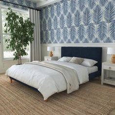 a bedroom with blue and white wallpaper, a large bed and two nightstands