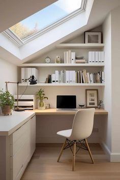 an attic office with skylight and desk