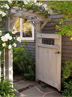 an outside view of a house with flowers on the door and in the yard area