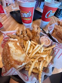 chicken sandwich with fries and coleslaw on the side at a fast food restaurant