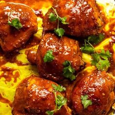 meatballs covered in sauce and garnished with parsley