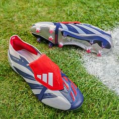 two soccer cleats sitting on the grass next to each other