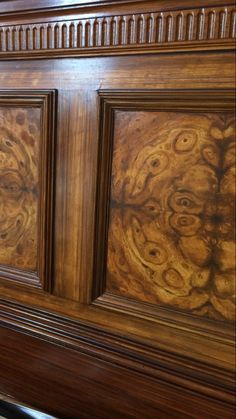 an ornate wooden headboard with intricate carvings on the sides and wood grained panels