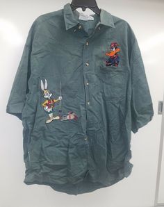 Used acne clothing company size extra large short-sleeve button-up shirt embroidered with bugs and Daffy Casual Embroidered Cotton Camp Shirt, Silly Button Up Shirt, Bugs And Daffy, Bug Button Up Shirt, Fitted Vintage Button-up Camp Shirt, Embroidered Button Up Shirt, Cheap Vintage Button-up Camp Shirt, Vintage Green Button-up Shirt, Acne Clothing