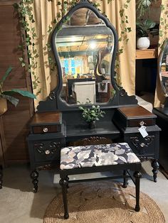 an antique vanity with mirror and stool in front of it