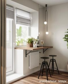 an empty kitchen with two stools next to the window and plants on the counter