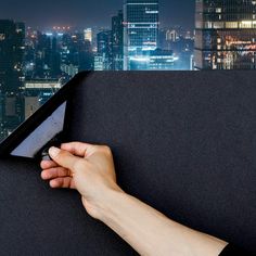 a person holding a knife in their hand on top of a building