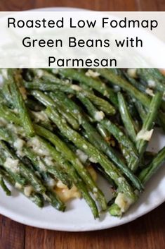 roasted low fodmap green beans with parmesan on a white plate