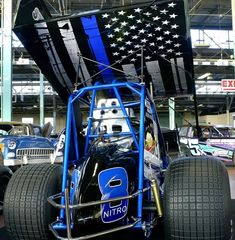 a blue race car with an american flag on it