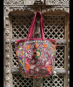 About bag  Indo-gypsy fusion, everyday use hand bag made from Banjara fabrics sourced from Vintage tribal costumes of regions of Rajastan and Gujarat. These are embellished with light catching coins, and intricate bead work tassels. Size - length 15 inches/ width 21 inches Company details:  Company name: Houseoftextile  Contact number: +919784447473  Email id: houseoftextile77@gmail.com  Shipping & custom : Delivery through one of the finest service providers : Skyway, Fedex, UPS  And DHL. Any l Bohemian Potli Bag With Mirror Work For Festive Occasions, Handmade Festival Hobo Tote Bag, Bohemian Multicolor Potli Bag For Festive Occasions, Bohemian Multicolor Potli Bag For Festive Season, Multicolor Bohemian Potli Bag For Festive Occasions, Bohemian Shoulder Bag With Zari Work For Festivals, Embroidered Hobo Bag For Festivals And Daily Use, Traditional Pink Tote Bag, Festival Bag With Mirror Work, Rectangular Shape