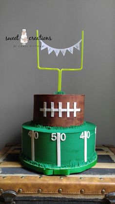 a football themed birthday cake on top of a suitcase