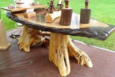 a table made out of tree trunks and logs