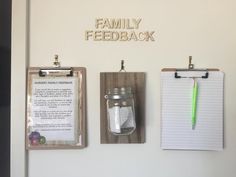 three clipboards and two magnets are hanging on the wall next to each other