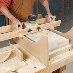 a man working on a piece of wood with a circular sawtoothing device in his hand