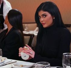 a woman sitting at a table eating food