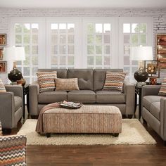 a living room filled with furniture and pillows