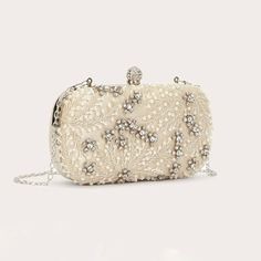 This stylish evening bag is the perfect accessory to any formal look. Crafted with a sparkly rhinestone and faux pearl decor, this mini bag adds an elegant touch to any special occasion. Show off your perfect style with this timeless and classic evening bag. Formal Looks, Evening Bags, Mini Bag, Faux Pearl, Special Occasion