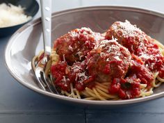 spaghetti and meatballs with sauce in a bowl