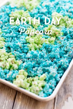 blue and green popcorn in a pan with the words earth day papoo on it