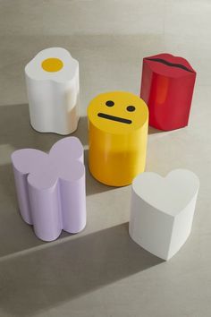 four different colored boxes with faces on them