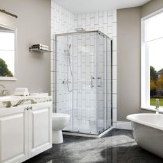 a bathroom with a tub, toilet and shower stall in the middle of the room