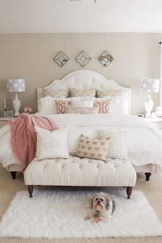 a white bed sitting in a bedroom next to a window