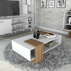 a living room filled with furniture and a flat screen tv on top of a wooden table