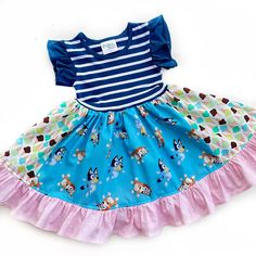 Our Bluey & Bingo dress is fashioned in our knit flutter style bodice & a cotton ruffle skirting, perfect for wowing the crowd! Hand designed from a delightful mix of prints that please & colors that pop. Great for Bluey birthday parties, gift giving, presents, & everyday wear! All designs are tagged in the even size.12mo/18mo: 17" 2/3: 21" 4/5: 24" 6/7: 26" 8: 28” 8/10: 31” 12: 33”Chest width unstretched: sz 12mo/18mo: 20" 2/3: 22.5" 4/5: 23.5" 6/7: 26" 8: 28"*This listing is for the dress only! Outfit options can be found in the drop down menu!Ships in 2-5 days! Bluey Bingo, Bluey Birthday, Outfit Options, Hand Designs, Gift Giving, Bingo, All Design, Birthday Parties, Bodice