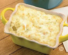 a casserole dish with cheese and crackers on the side next to it