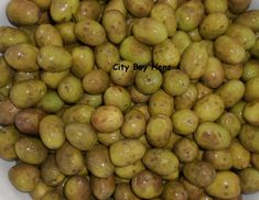 a white bowl filled with lots of green fruit