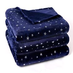 three blankets stacked on top of each other with stars printed on them in blue and white