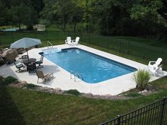 an above ground pool surrounded by lawn chairs