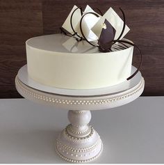 a white cake with chocolate decorations on top