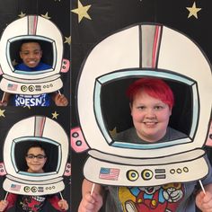 two children are smiling and holding up cardboard cutouts to look like an astronaut's helmet