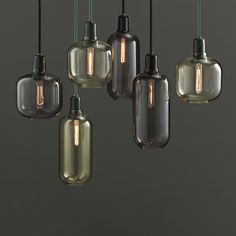 five glass pendant lights hanging from the ceiling