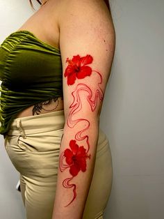 a woman with red flowers painted on her arm