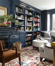 a living room filled with lots of furniture and bookshelves next to a fire place