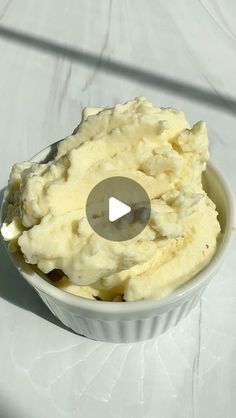 a bowl filled with mashed potatoes on top of a table